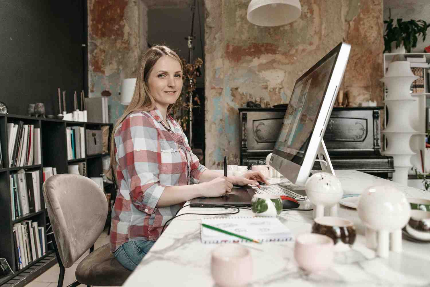 https://www.pexels.com/photo/woman-in-plaid-shirt-sitting-working-in-an-office-7675022/