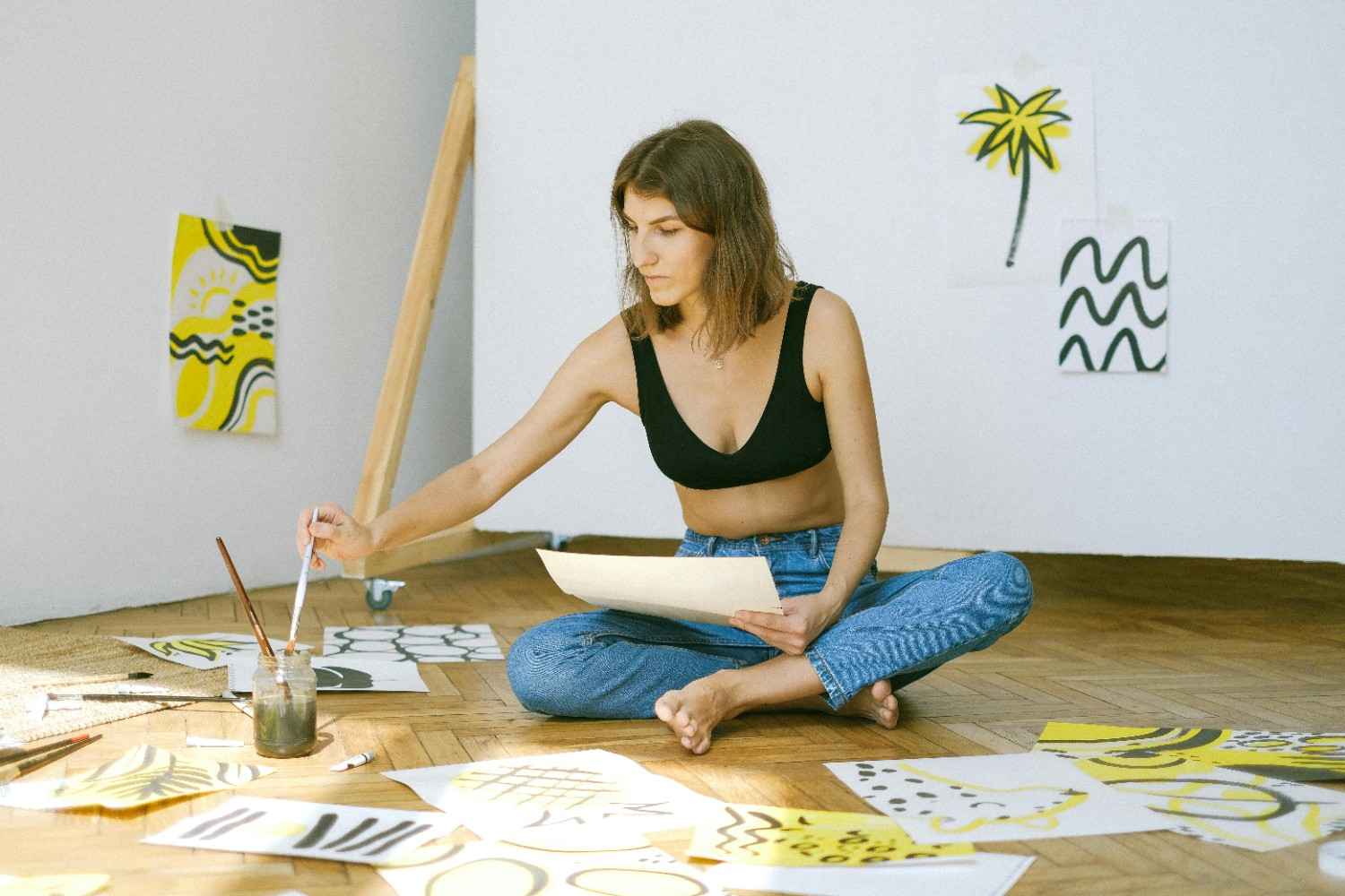 https://www.pexels.com/photo/photo-of-woman-sitting-on-floor-while-painting-4483167/