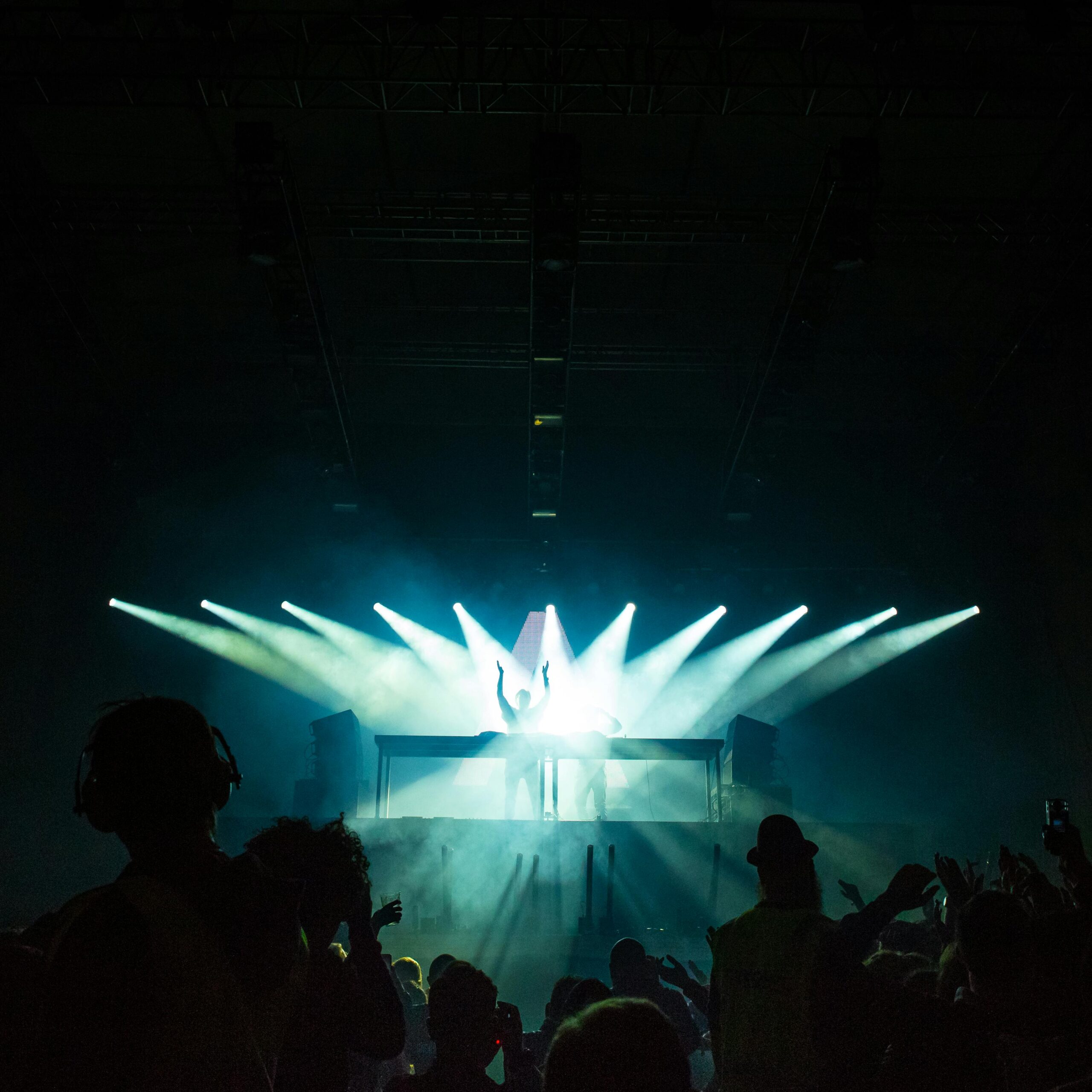 A DJ performing live, skillfully using a crossfader to blend two tracks seamlessly.